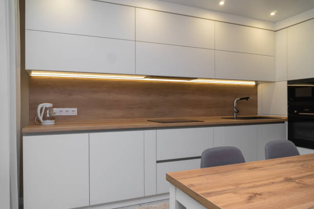 istock Beautiful modern minimalistic interior of a bright kitchen with lighting 1324741146
