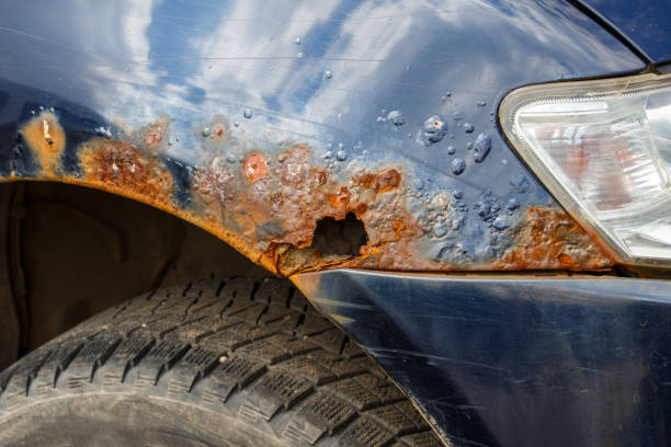 rusted through blue car wing close-up with selective focus rusted through blue car wing close-up with selective focus. distressed rusty vintage pickup truck close up detail stock pictures, royalty-free photos & images