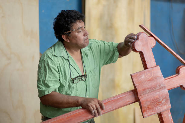 istock Mexican carpenter sanding a wood cross 1324746508