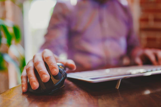 istock Man in purple shirt working with a computer 1324747940