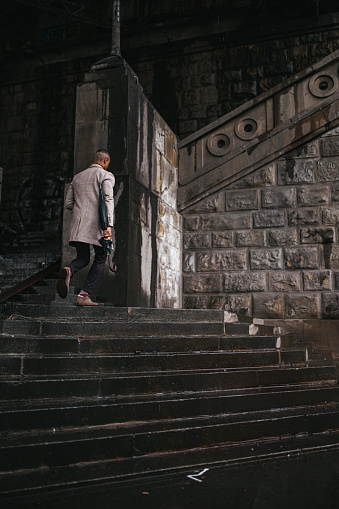 A young businessman climbs the stairs