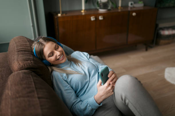 istock Beautiful Caucasian woman using a smart phone at home 1324751172