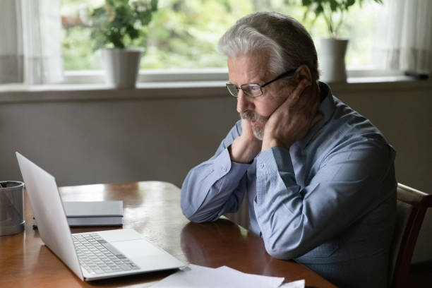 istock Pensive old Caucasian man work on laptop thinking 1324756523