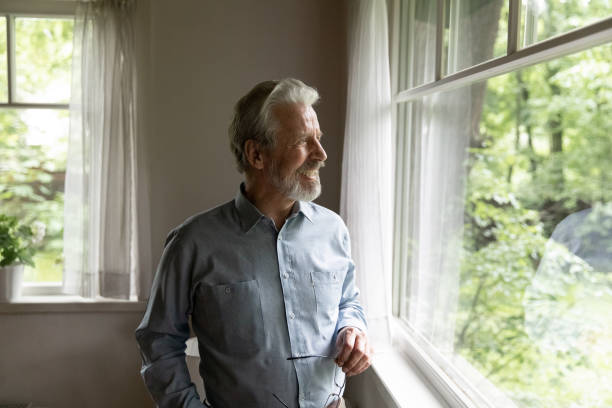 istock Smiling old man look in window enjoy healthy maturity 1324756552