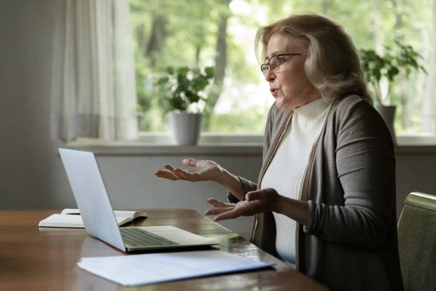 istock Unhappy mature woman confused with computer breakdown 1324756618