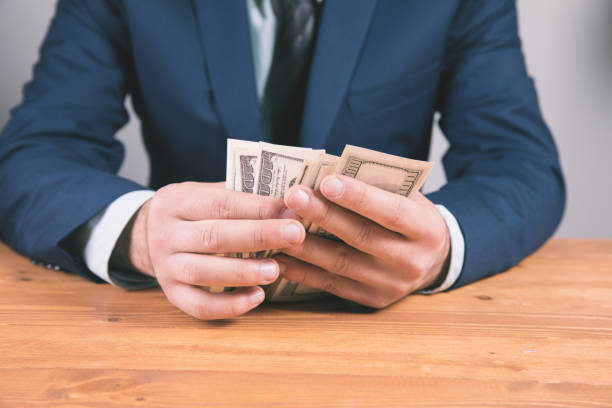 istock young man counts money calculating money 1324758656