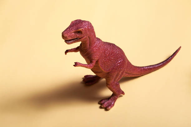 istock Toy plastic dinosaur on a colored background. Concept texture, design, wallpaper, decor, textiles 1324759718