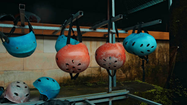 Colored protective helmets for the head to practice rafting hanging on the wall