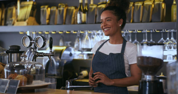 istock Shot of a young woman smiling while working in a cafe 1324761051