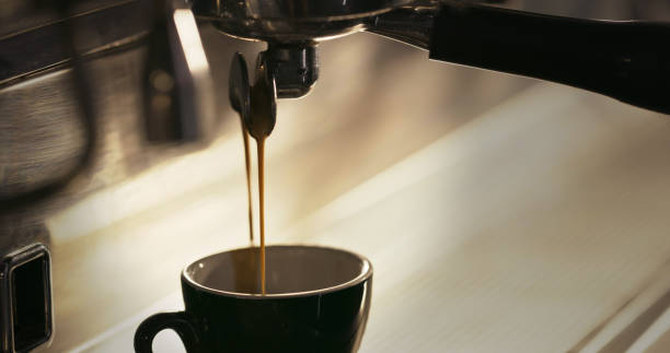 istock Shot of coffee poring into a cup from a coffee machine 1324761055