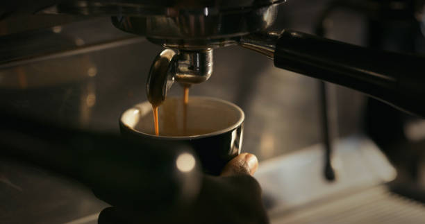 istock Shot of coffee poring into a cup from a coffee machine 1324761062
