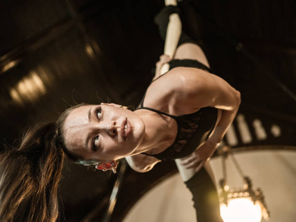 istock Young female aerial silk performer at practice 1324761607