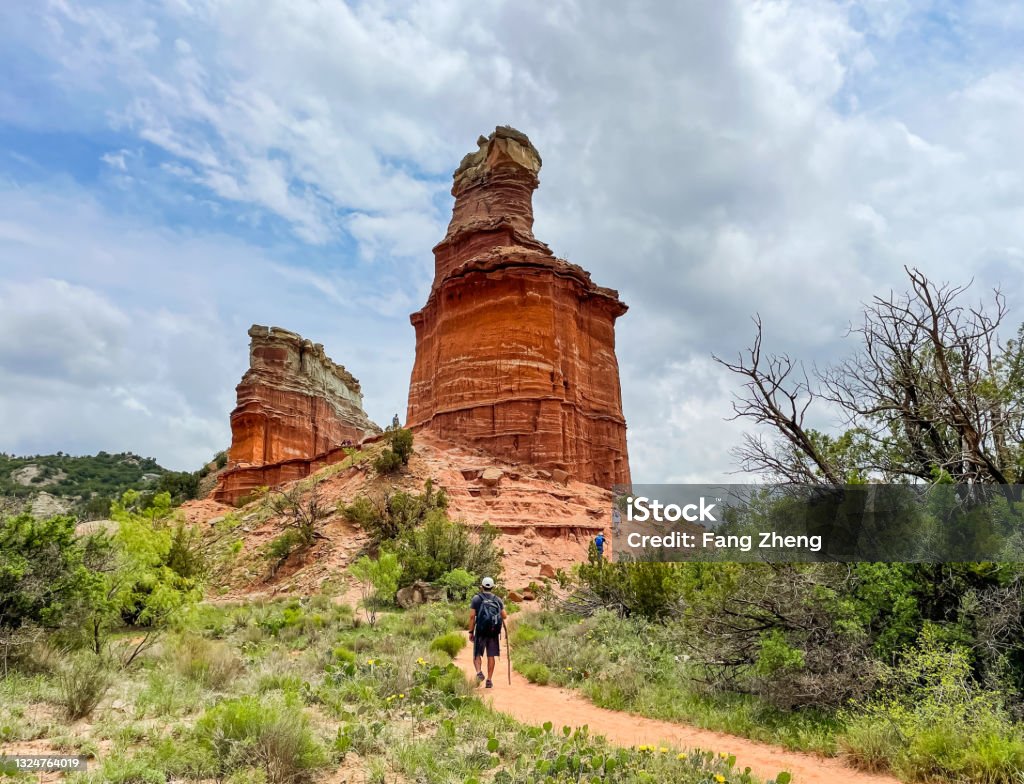 Palo Duro Canyon State Park Close up view of Lighthouse symbol rock with visitors walking towards it in Palo Duro Canyon State Park Palo Duro Canyon State Park Stock Photo