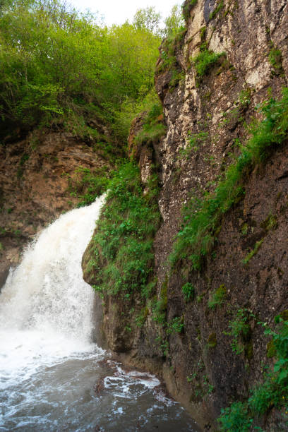 istock Beautiful waterfall with a stunning forest in the background on a nice sunny day. 1324765100