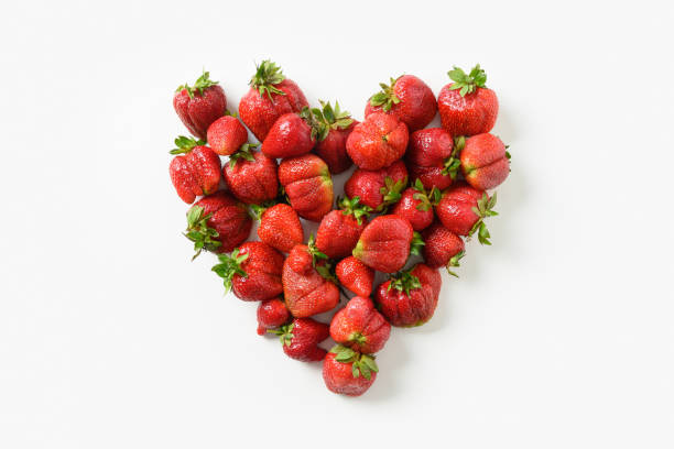 istock Ugly three ripe organic strawberry on black background. 1324766802