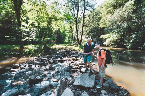 istock Happy grandfather and grandson crossing a river 1324767856