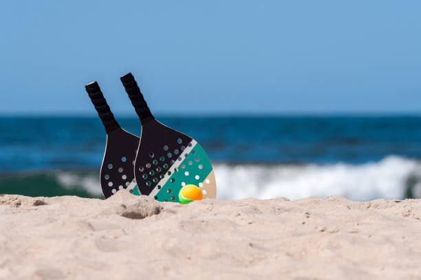 istock Rackets and ball on the sandy beach. Summer sport concept 1324767914