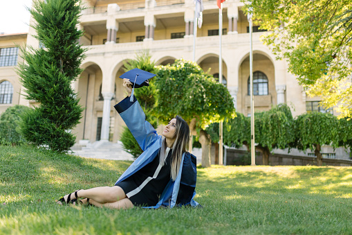 Canada - June 13, 2023: A procession of graduating university students in formal academic gowns go in to receive their diplomas