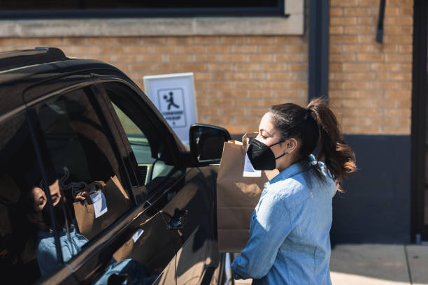 istock Restaurant worker delivers curbside pickup order 1324768881
