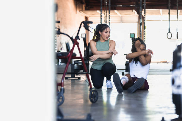 istock Personal trainer assists athlete with a disability 1324768887
