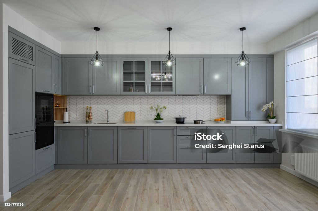 Trendy grey and white modern kitchen furniture, front view Trendy grey and white modern kitchen furniture showcase, front view Kitchen Stock Photo