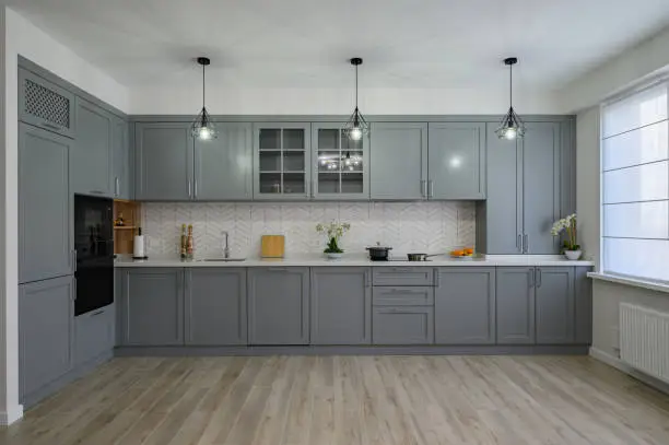 Trendy grey and white modern kitchen furniture showcase, front view