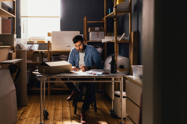istock Handsome Male Employee Organizes Packages at Storage Warehouse 1324771200