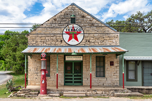 Austin, Texas – June 20, 2021: An old abandoned Texaco gas station in Rural Texas outside of Austin city limits. Photo taken during a warm summer day.