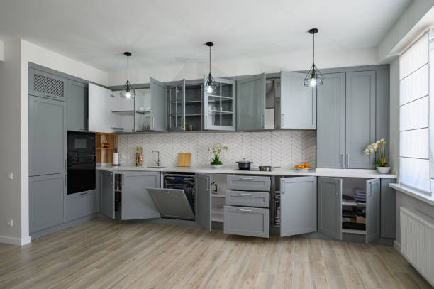 istock Trendy grey and white modern kitchen furniture with doors open 1324772433