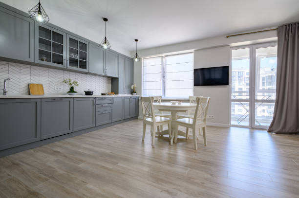 istock Trendy grey and white modern kitchen furniture in studio apartment 1324772667
