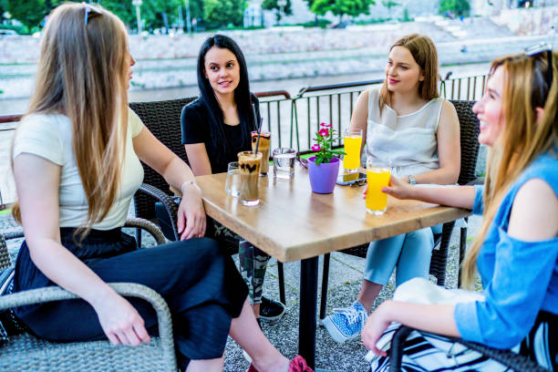 istock Four female friends having fun at cafe 1324775874