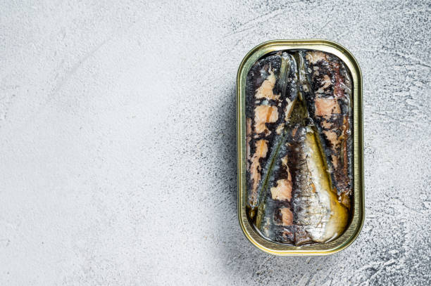 istock Open can with sardine in olive oil. White background. Top view. Copy space 1324779556