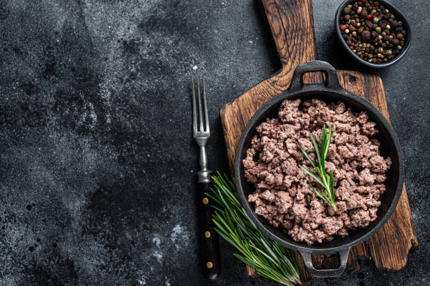 istock Fried mince beef meat in a pan for cooking pasta. Black background. Top view. Copy space 1324782016