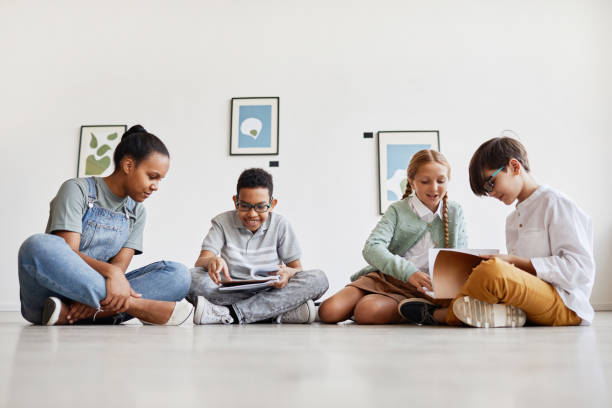 istock Kids Sitting on Floor in Art Gallery 1324782167
