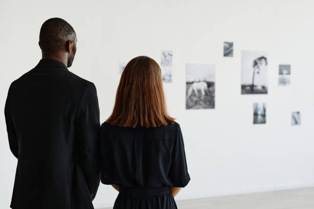 istock Couple Wearing Black in Art Gallery 1324782219