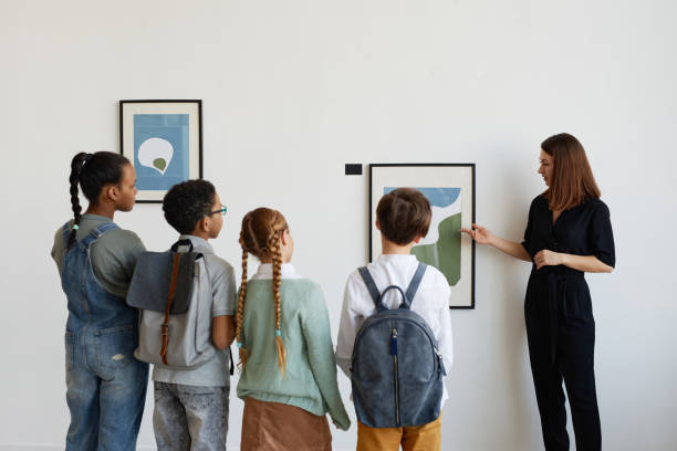 istock Children Looking at Paintings in Gallery Back View 1324782228