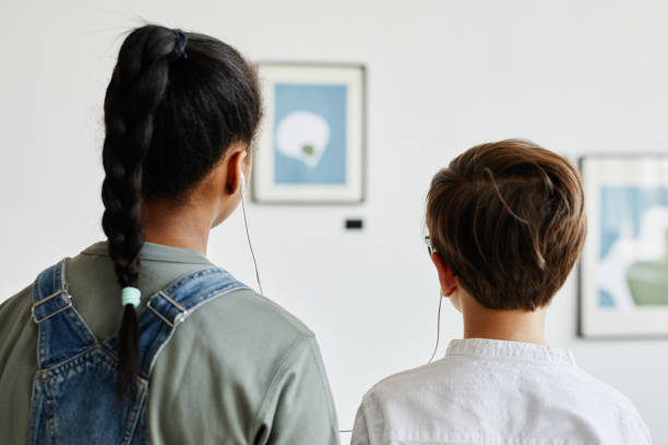 children using audio guide in art gallery - museum child art museum art imagens e fotografias de stock