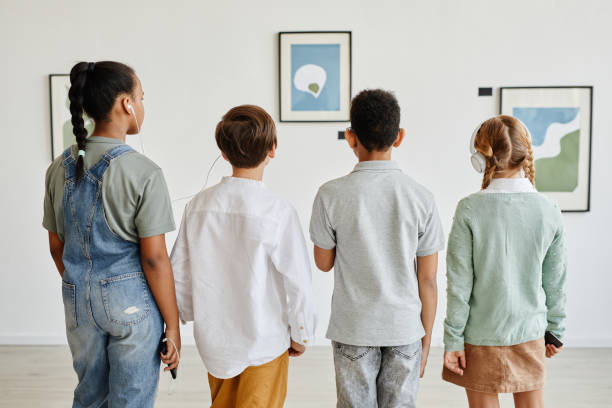 kids using audio guide in art gallery - group of people art museum clothing lifestyles imagens e fotografias de stock