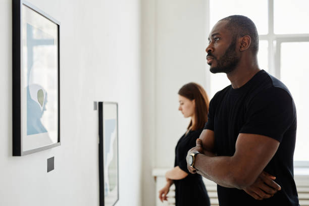 istock People Looking at Painting in Art Gallery 1324782294