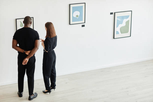 istock Couple Looking at Painting in Modern Gallery 1324782297