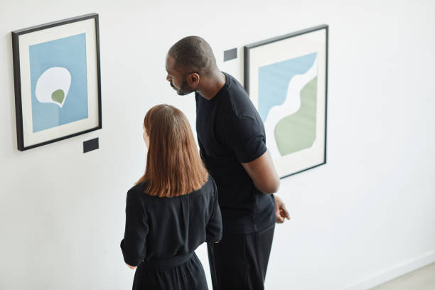 istock Two People Looking at Painting in Art Gallery 1324782302