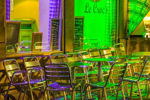The City of Colmar France on April 13, 2014:  Metal chair seating at an outdoor cafe and bar at night in Colmar, France