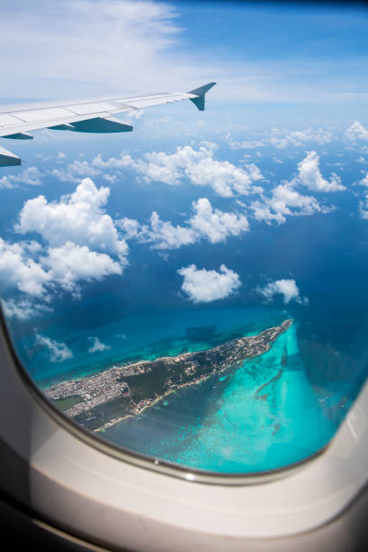 Isla Mujeres in Mexico viewed from airplane window View from an airplane window of Isla Mujeres, an island off the coast of Cancun, Mexico isla mujeres stock pictures, royalty-free photos & images