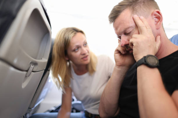istock Man with headache with his eyes closed on plane 1324789104