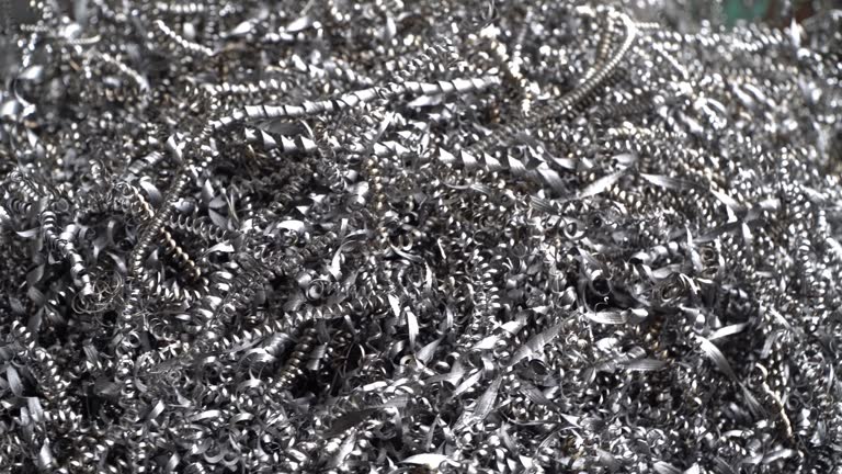 Steel scrap materials recycling. Aluminum chip waste after machining metal parts on a cnc lathe