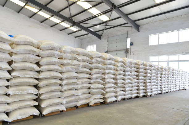 istock Many rows of plastic white sacks with goods are in big warehouse 1324792688