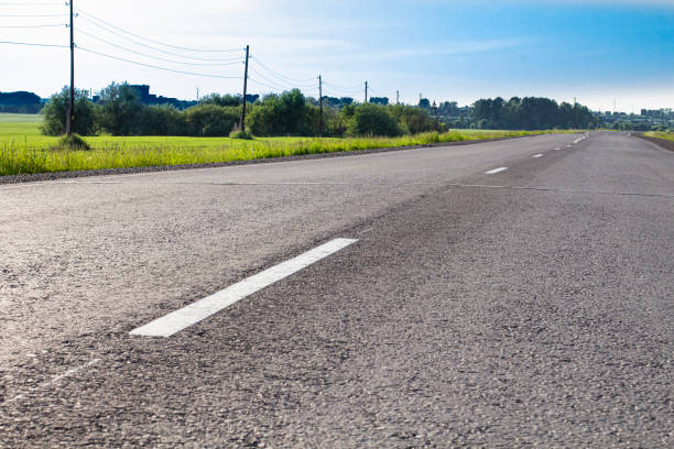 istock Asphalt road with road markings, evening bright sunlight 1324798570