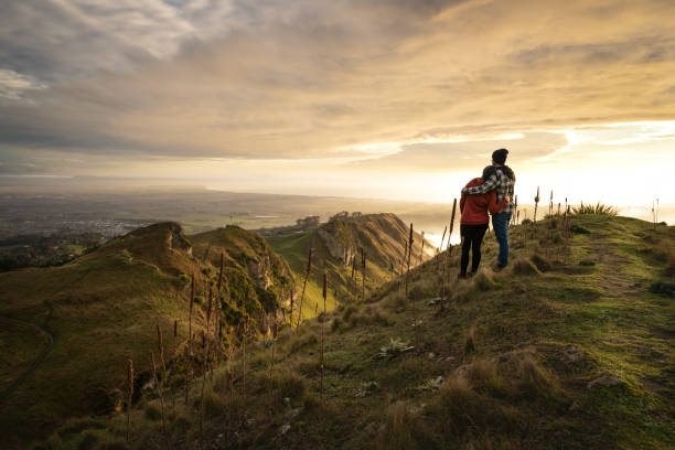 istock Couple embracing each other on the peak on a mountain 1324800203