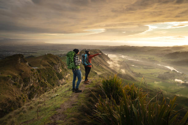 Two travelers walking on the Te Mata Peak in New Zealand. stock photo