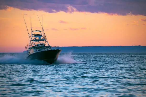 Boat, yacht cruising at sunset